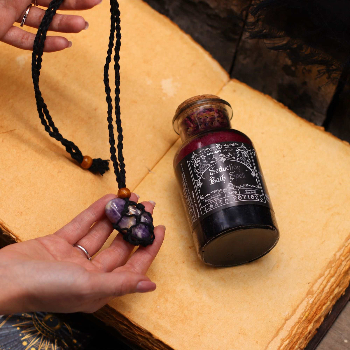 Ancient Witch Bath Spell Potion in apothecary bottle with rock crystal amulet and layered cleansing salts and herbs